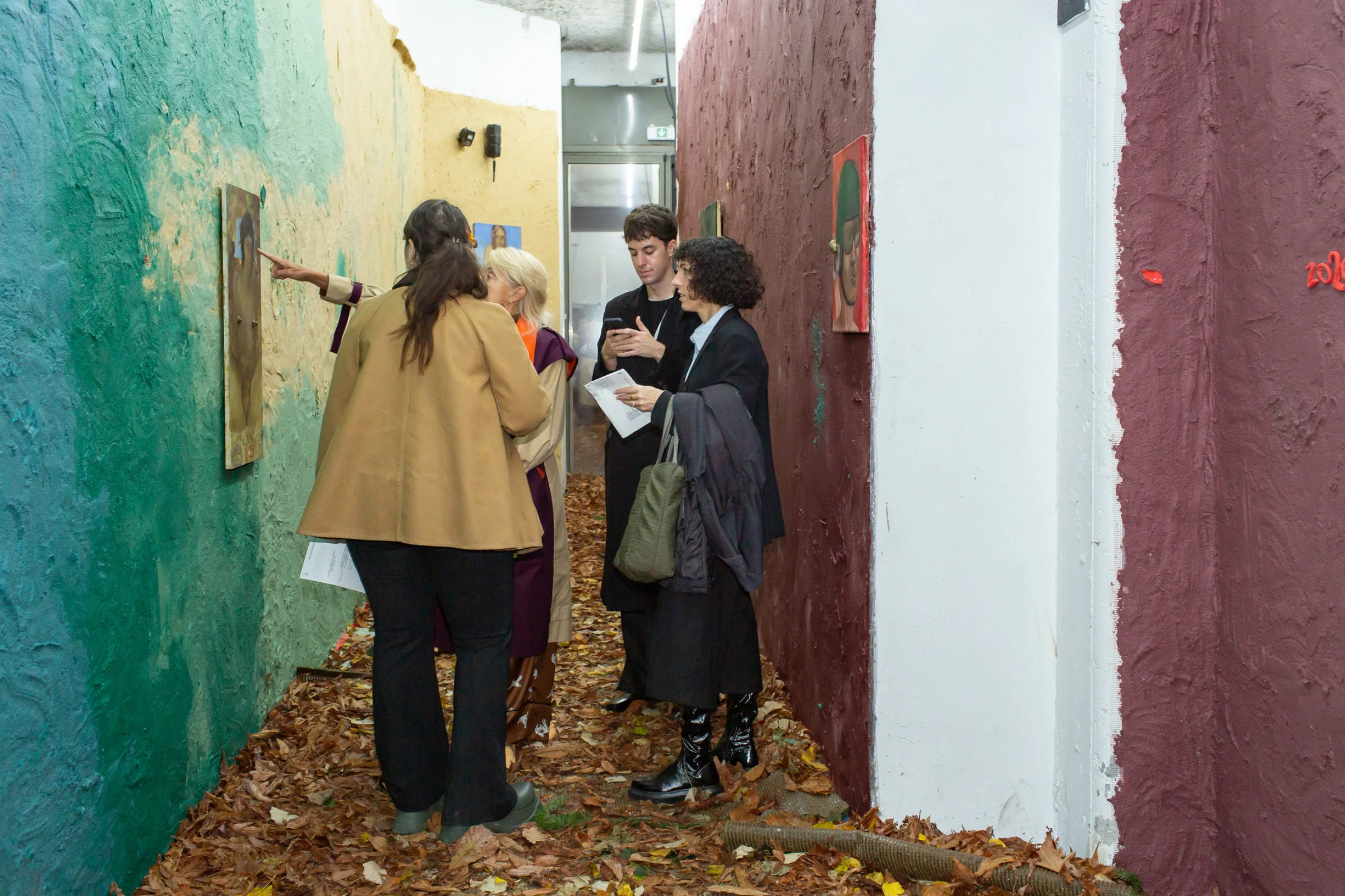 Crowd view inside a contemporary art fair booth presentation during preview days.