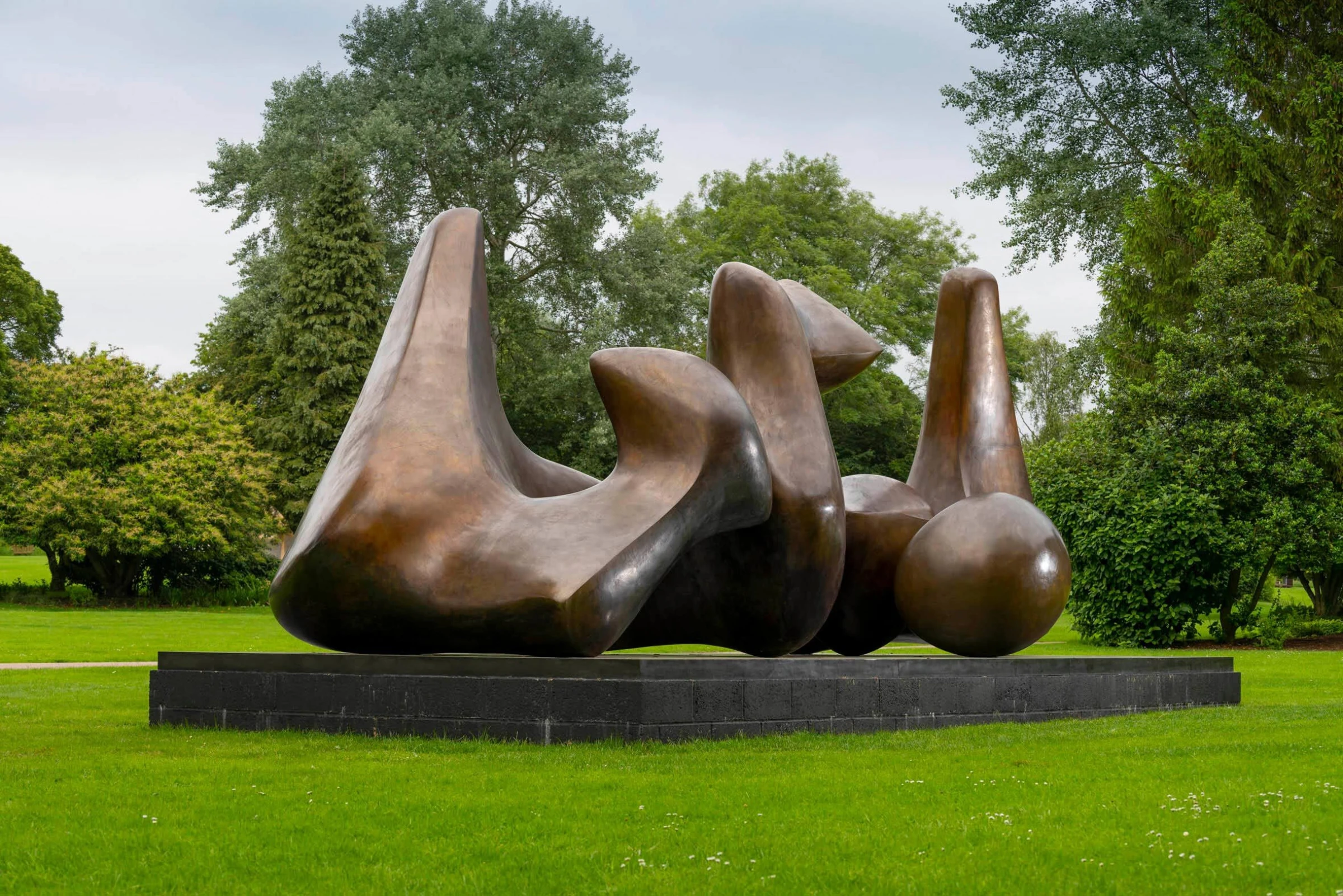 Large outdoor bronze sculpture installed in a landscaped setting, illustrating the scale and siting demands of monumental commissions.