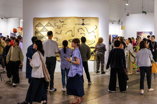 Gallery view of a museum collection installation with visitors moving through large-scale works.