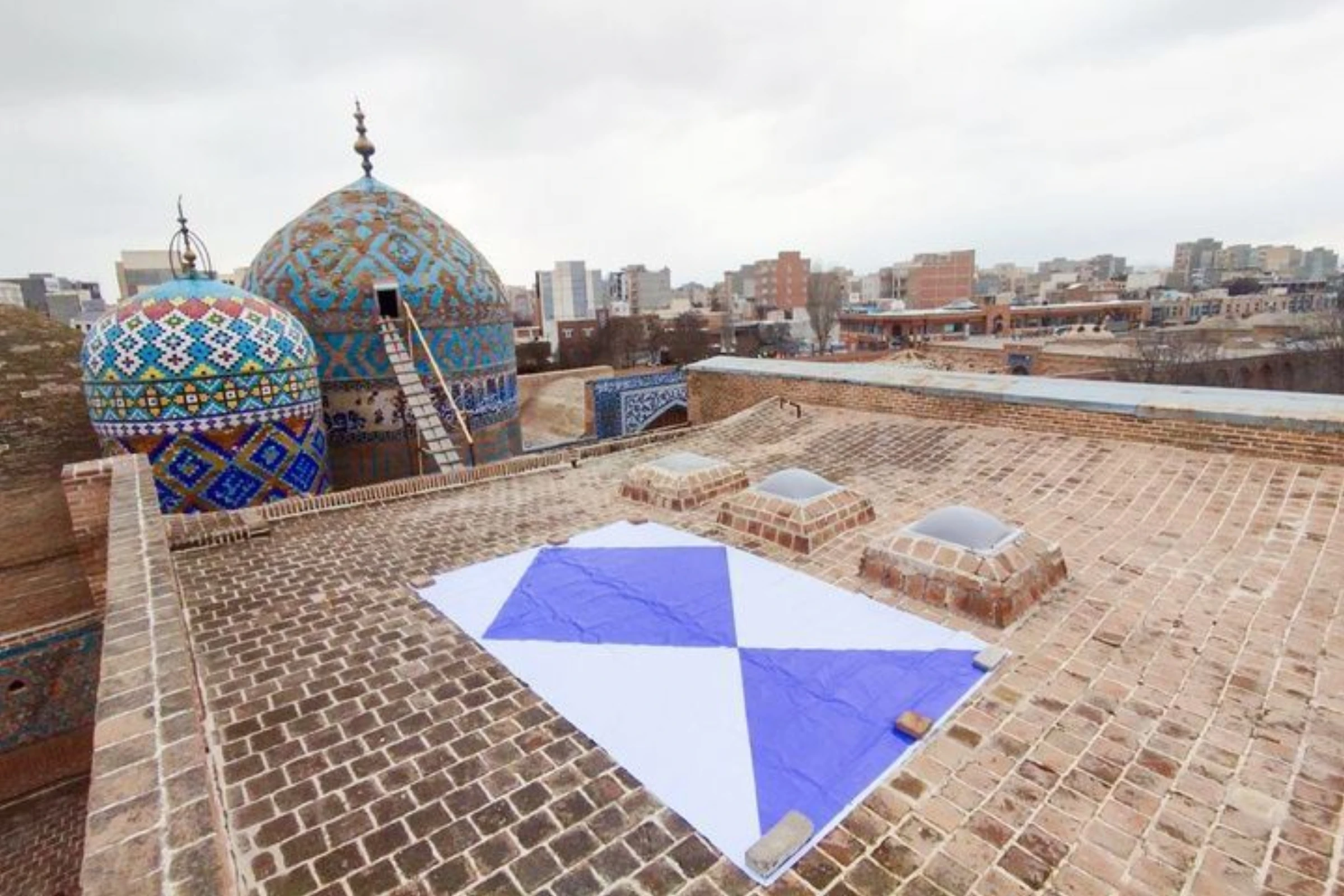 Historic structures in Isfahan showing broken windows and visible surface damage after nearby strikes.