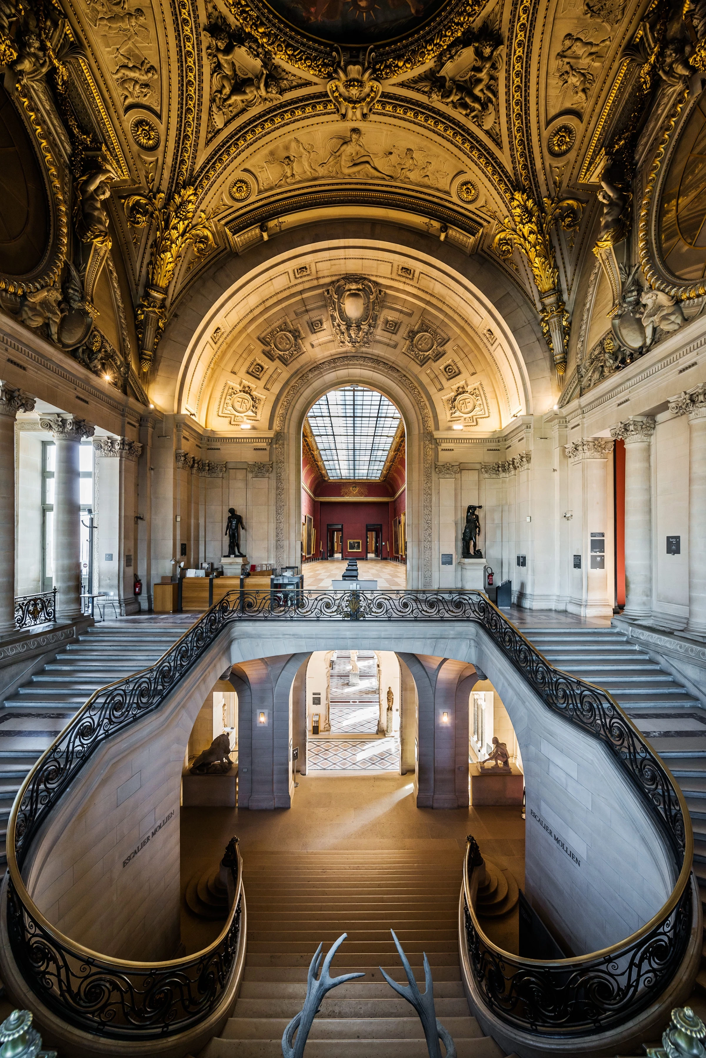 Historic staircase interior in the Louvre’s Denon wing.