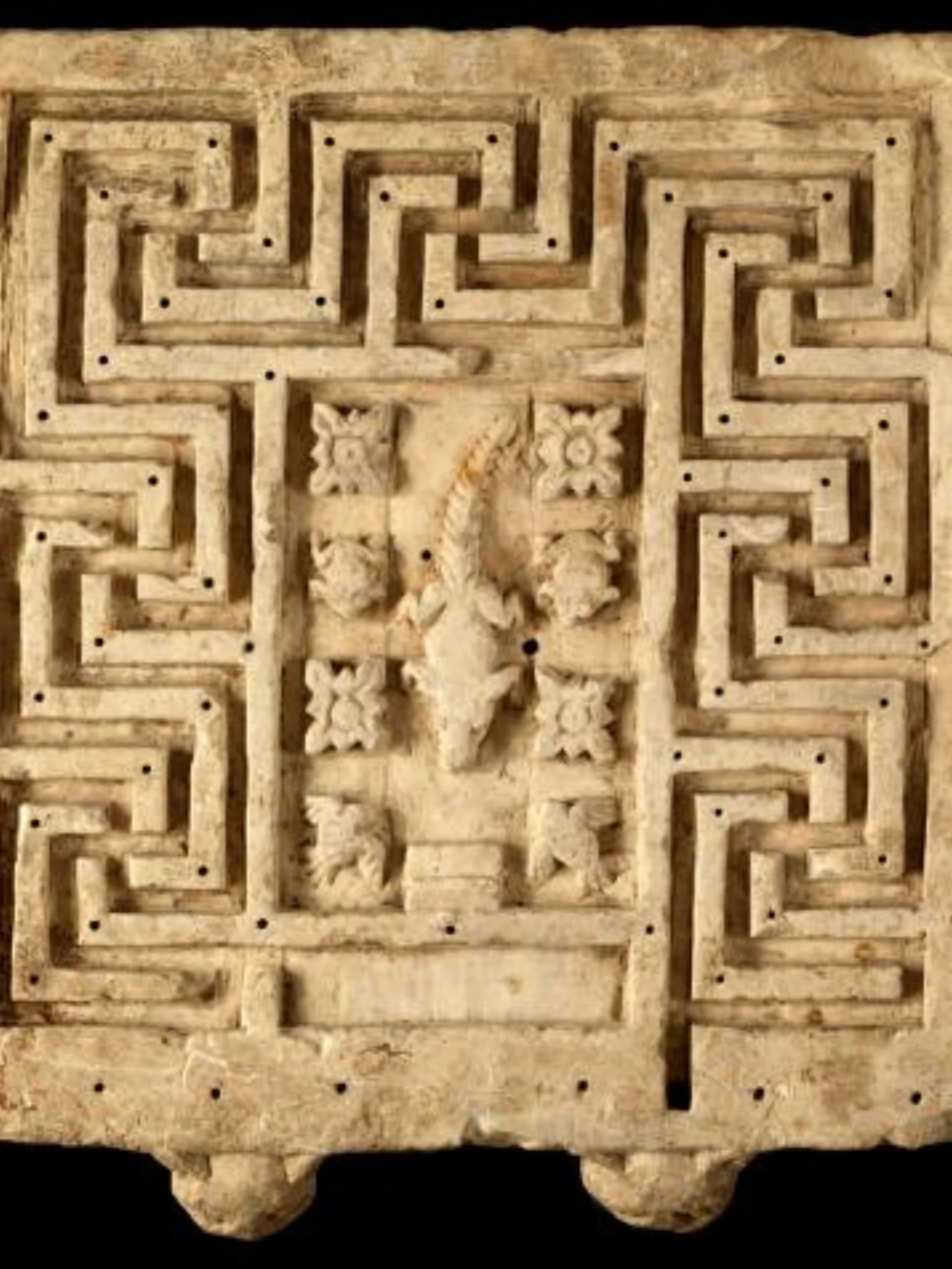 Gallery interior at the Louvre with historic painted works on the walls.