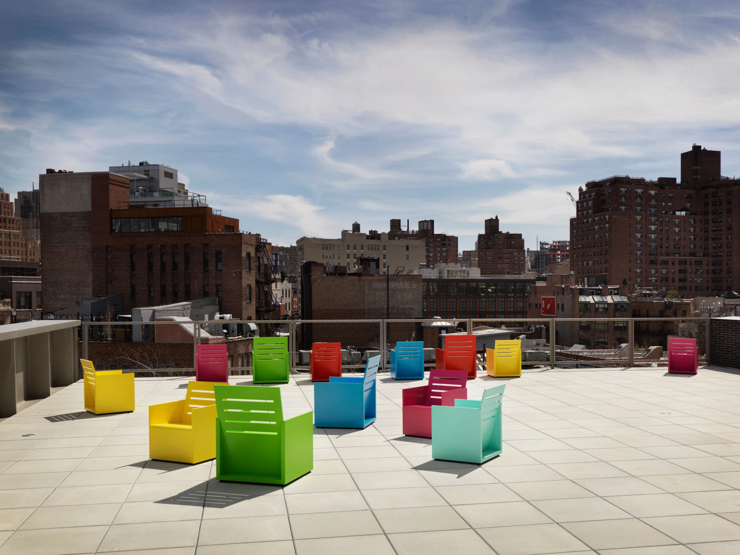 Installation view of Mary Heilmann's exhibition at the Whitney Museum of American Art, featuring her colorful abstract paintings and sculptural furniture