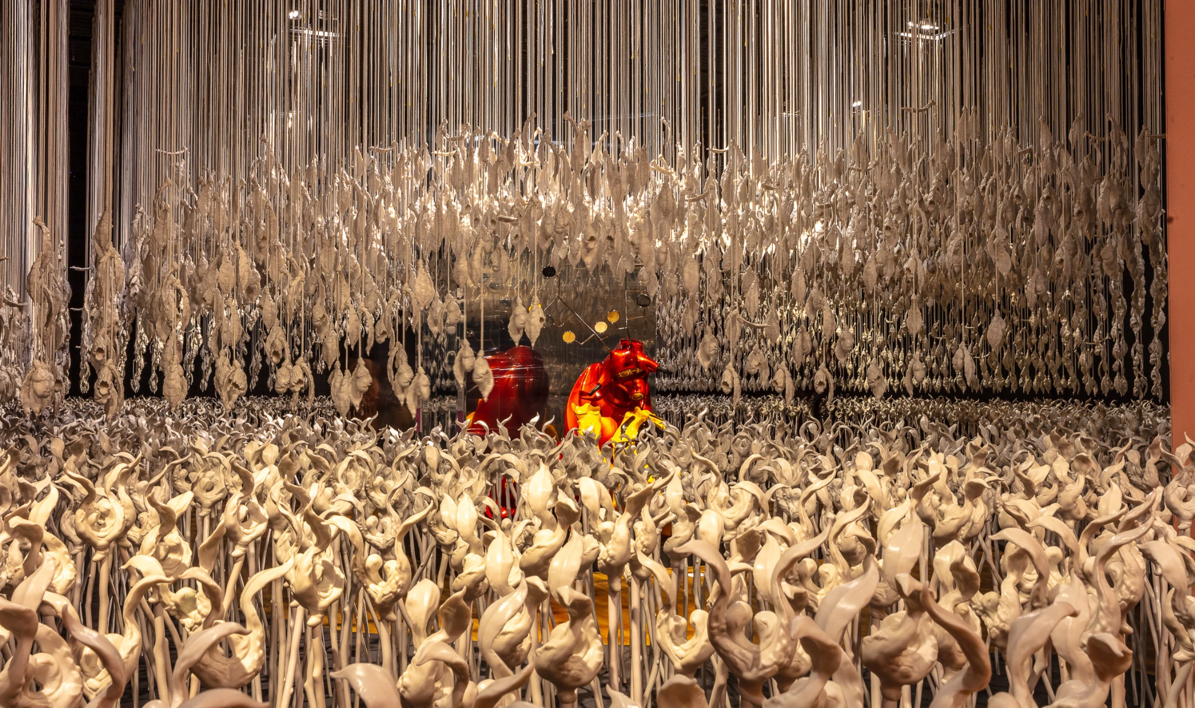 Installation image from a Patricia Piccinini exhibition featuring hybrid sculptural forms.